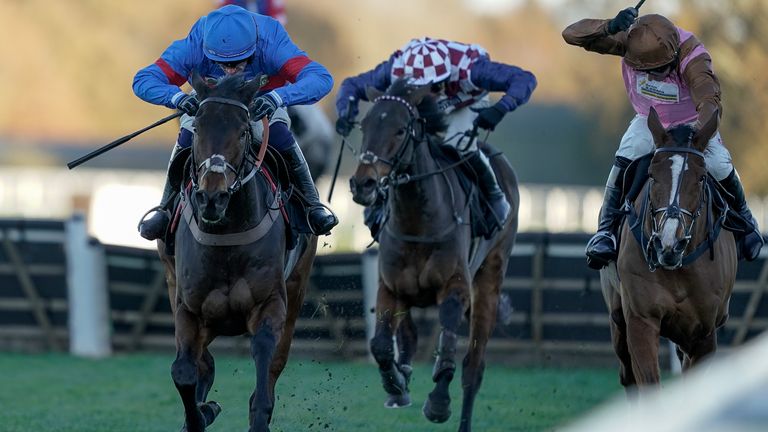 Jonathan Burke riding Gin Coco (blue) clear the last to win The Garden For All Seasons Handicap Hurdle at Ascot
