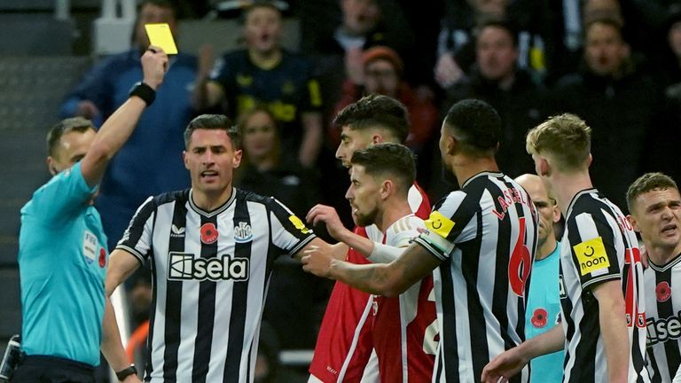 Arsenal's Kai Havertz is shown a yellow card for a foul on Newcastle United's Sean Longstaff