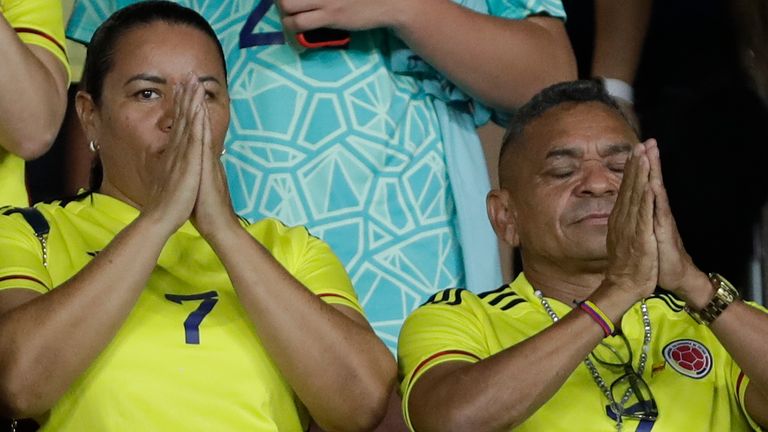 Parents of Colombia's soccer player Luiz Diaz, Luis Manuel D..az, right, and Cinelis Marulanda , holds their hands in prayer before the start a qualifying soccer match between Colombia and Brazil for the FIFA World Cup 2026, at the Roberto Melendez stadium in Barranquilla, Colombia, Thursday, Nov. 16, 2023. The father of Liverpool striker Luis D..az was released Thursday by members of a guerrilla group who kidnapped him in northern Colombia, the government announced, ending a 12-day ordeal for the family. (AP Photo/Ivan Valencia)