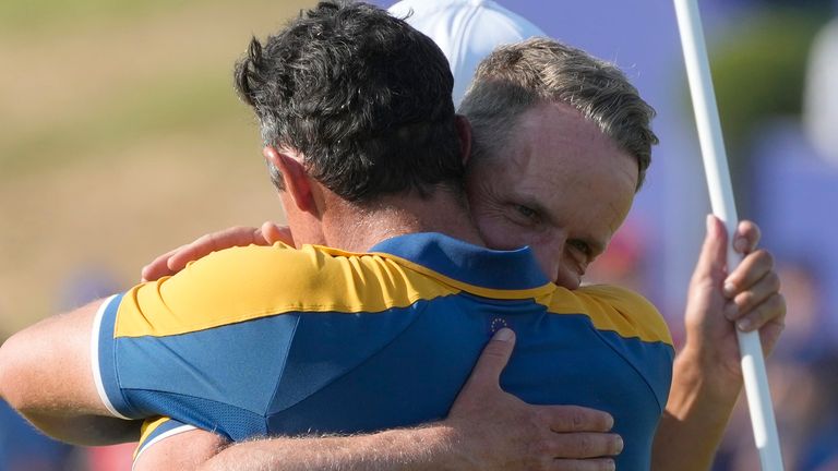 Europe&#39;s Rory McIlroy, left is embraced by Europe&#39;s Team Captain Luke Donald on the 17th green after winning his singles match at the Ryder Cup golf tournament at the Marco Simone Golf Club in Guidonia Montecelio, Italy, Sunday, Oct. 1, 2023. (AP Photo/Gregorio Borgia)