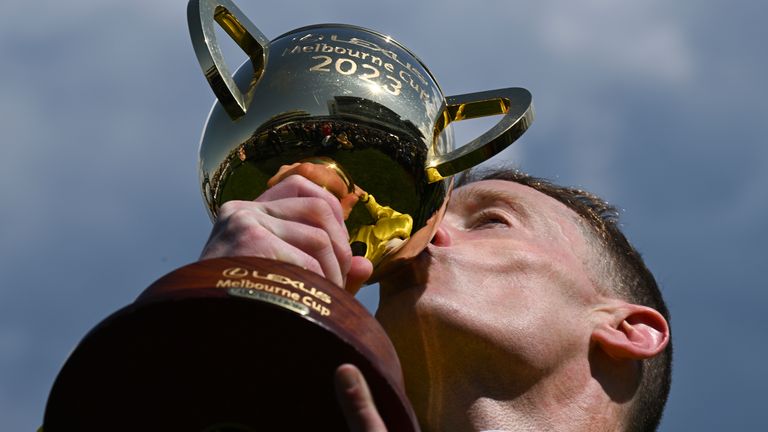 Jockey Mark Zahra kisses the Melbourne Cup trophy after riding Without A Fight to win the Melbourne Cup at Flemington Racecourse in Melbourne, Australia, Tuesday, Nov. 7, 2023. (James Ross/AAP Image via AP)