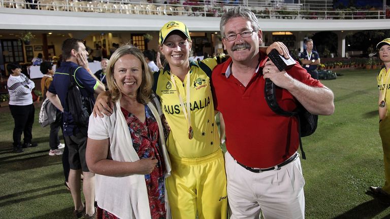 Meg Lanning with her parents Sue and Wayne after Australia's victory in the final against West Indies in 2013