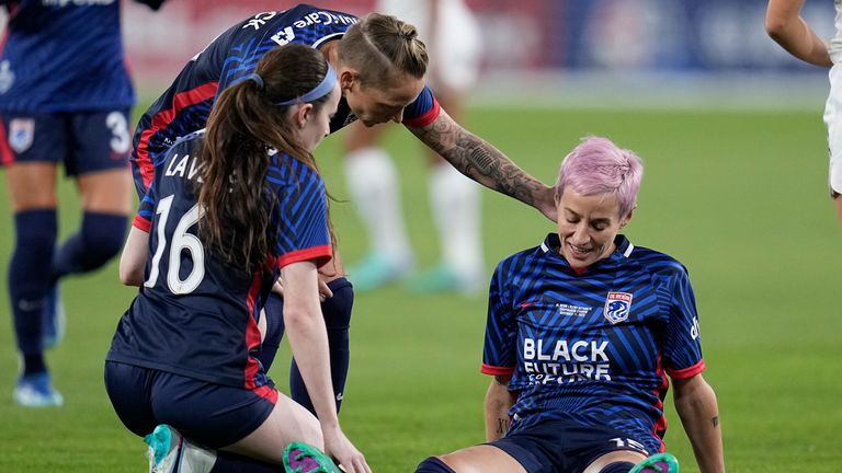 OL Reign forward Megan Rapinoe, right, stays down after sustaining a non-contact injury