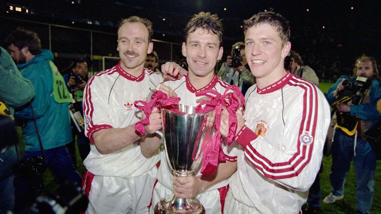 Manchester United captain Bryan Robson (c) celebrates with the trophy with team mates Mike Phelan (l) and Lee Sharpe (r) after the 1991 UEFA European Cup Winners Cup Final between Manchester United and Barcelona on May 15th, 1991 in Rotterdam, Holland