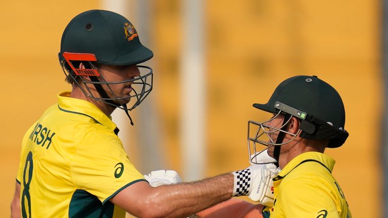 Australia's Mitchell Marsh celebrates his fifty runs with David Warner during the ICC Men's Cricket World Cup match between Australia and Bangladesh in Pune, India, Saturday, Nov. 11, 2023. (AP Photo/Rafiq Maqbool)