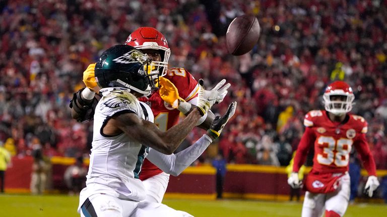 Philadelphia Eagles wide receiver DeVonta Smith, front, catches a pass as Kansas City Chiefs safety Mike Edwards (21) defends during the second half of an NFL football game, Monday, Nov. 20, 2023, in Kansas City, Mo.