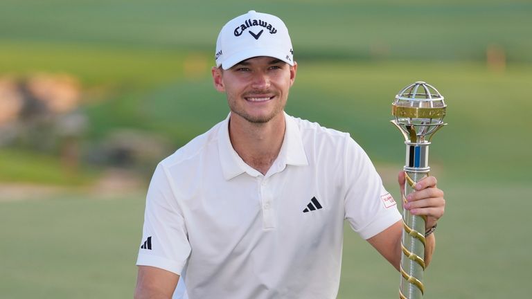 Nicolai Hojgaard of Denmark poses with his trophy after the won the final round of the DP World Tour Championship golf tournament, in Dubai, United Arab Emirates, Sunday, Nov. 19, 2023. (AP Photo/Kamran Jebreili)