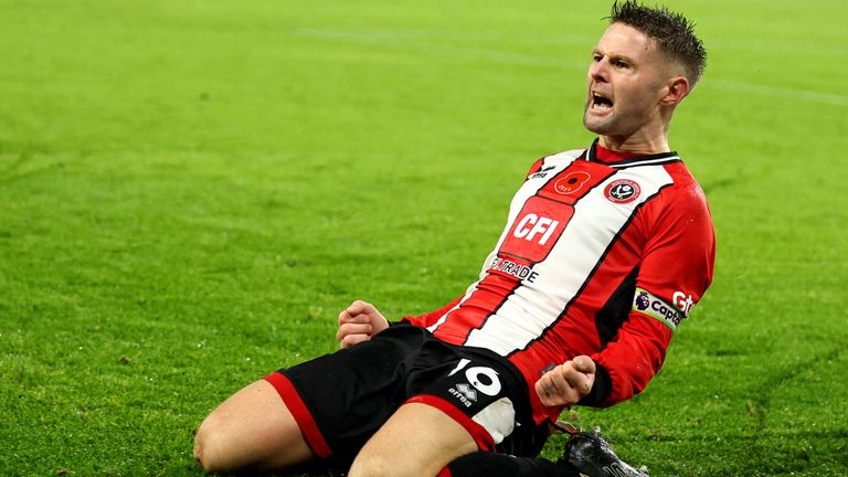 Oliver Norwood celebrates his late winner from the penalty spot