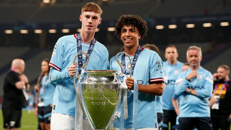 Cole Palmer (left) and Rico Lewis (right) won the treble with Man City last season