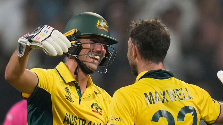 Australia&#39;s Glenn Maxwell, right, celebrates with captain Pat Cummins after their win in the ICC Men&#39;s Cricket World Cup match against Afghanistan in Mumbai, India, Tuesday, Nov. 7, 2023. (AP Photo/Rajanish Kakade)