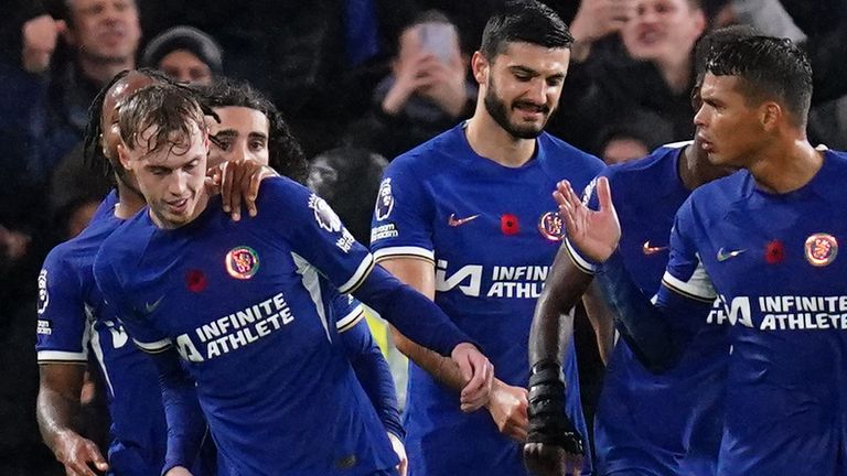 Cole Palmer is mobbed by his team-mates after scoring a stoppage-time penalty to earn Chelsea a 4-4 draw with Man City