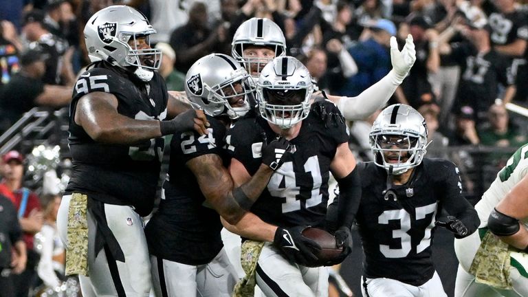 Las Vegas Raiders linebacker Robert Spillane (41) is congratulated by teammates after intercepting a pass during the second half of an NFL football game against the New York Jets Sunday, Nov. 12, 2023, in Las Vegas. (AP Photo/David Becker)