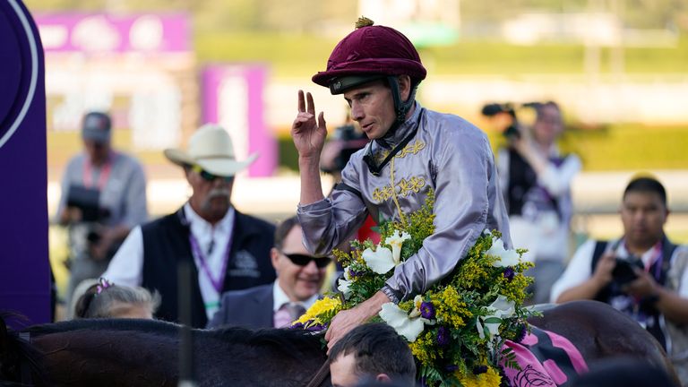 Ryan Moore celebrates atop Unquestionable after winning the Breeders' Cup Juvenile Turf