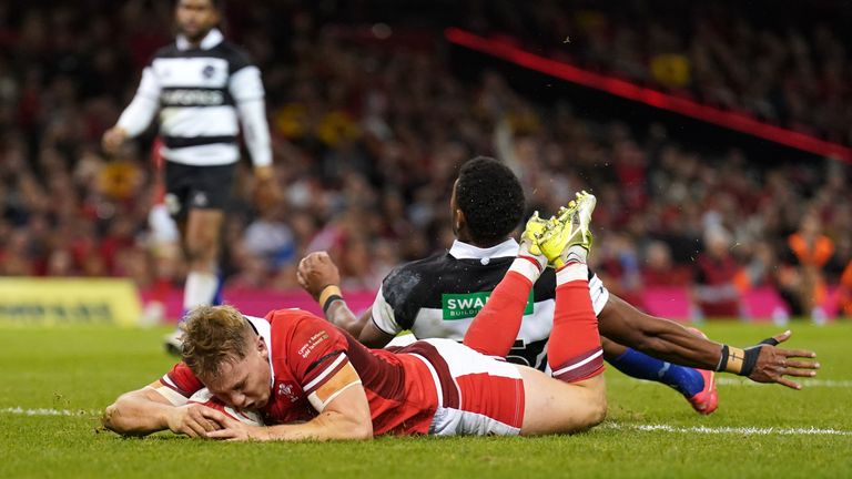Wales' Sam Costelow scores their side's third try of the game against the Barbarians 
