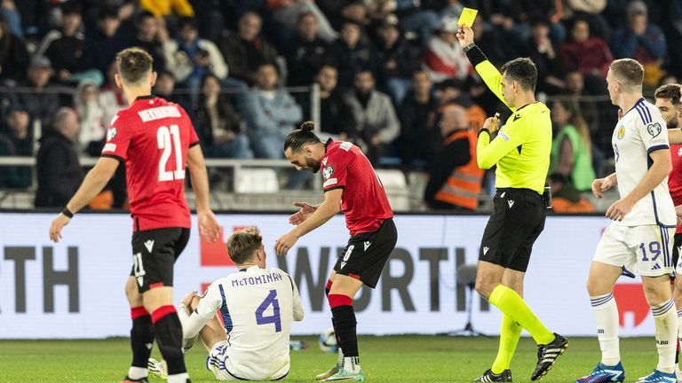 TBILISI, GEORGIA - NOVEMBER 16: Georgia&#39;s Giorgi Kochorashvili is shown a yellow card by Referee Aleksandar Stavrev after a tackle on Scotland&#39;s Scott McTominay during a UEFA Euro 2024 Qualifier between Georgia and Scotland at the Boris Paichadze Dinamo Arena, on November 16, 2023, in Tbilisi, Georgia. (Photo by Craig Williamson / SNS Group)