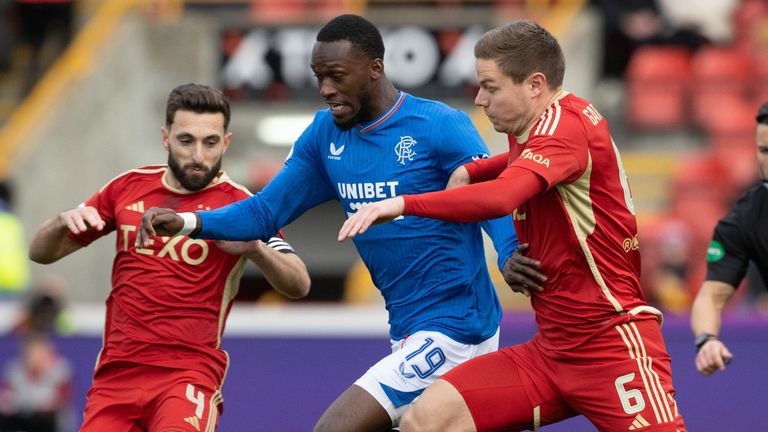 Graeme Shinnie and Stefan Gartenmann close down Abdallah Sima