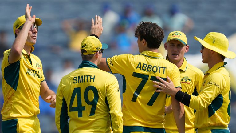 Australia's Sean Abbott celebrates the wicket of Bangladesh's Tanzid Hasan Tamim with teammates during the ICC Men's Cricket World Cup match between Australia and Bangladesh in Pune, India, Saturday, Nov. 11, 2023. (AP Photo/Rafiq Maqbool)