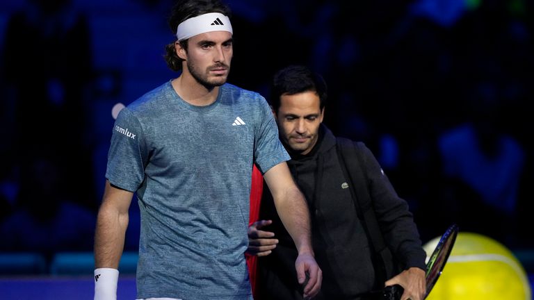 Greece's Stefanos Tsitsipas leaves the court after injuring during the singles tennis match against Denmark's Holger Rune, of the ATP World Tour Finals at the Pala Alpitour, in Turin, Italy, Tuesday, Nov. 14, 2023. (AP Photo/Antonio Calanni)