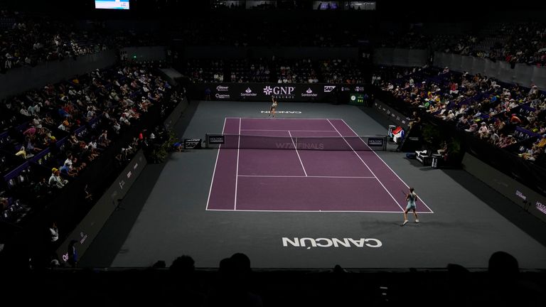 Jessica Pegula of the United States, back, serves to Maria Sakkari of Greece, during a women&#39;s singles match at the WTA Finals tennis championships, in Cancun, Mexico, Thursday, Nov. 2, 2023. (AP Photo/Fernando Llano)