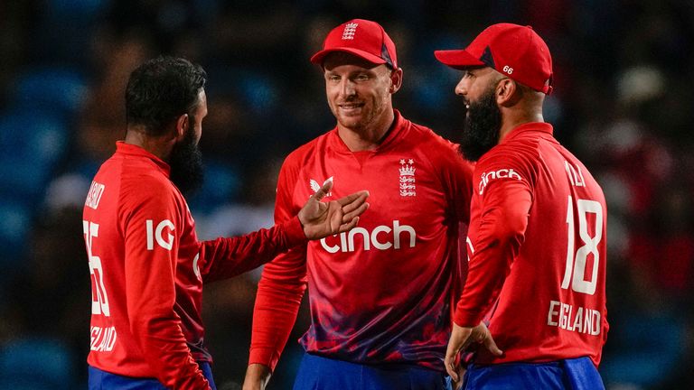 England&#39;s Adil Rashid, left, celebrates with captain Jos Buttler and Moeen Ali..taking the wicket of West Indies&#39; Johnson Charles during the fifth T20 cricket match at Brian Lara Stadium in Tarouba, Trinidad and Tobago, Thursday, Dec. 21, 2023. (AP Photo/Ricardo Mazalan)
