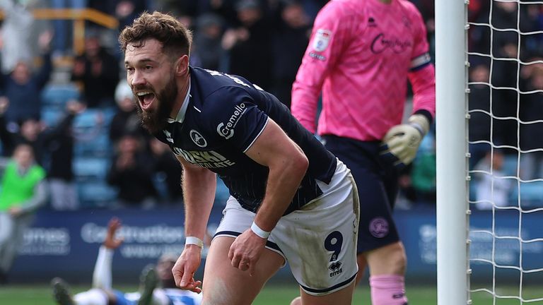 Tom Bradshaw wheels away in celebration after scoring for Millwall against QPR