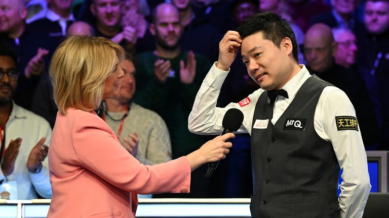 China's Ding Junhui (R) gives an interview after his defeat to England's Ronnie O'Sullivan in the final of the 2023 MrQ UK Championship at the York Barbican in York, Northern England on December 3, 2023. England's Ronnie O'Sullivan beat China's Ding Junhui 10-7 in the final. (Photo by Oli SCARFF / AFP)