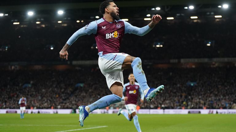 Douglas Luiz celebrates scoring his penalty
