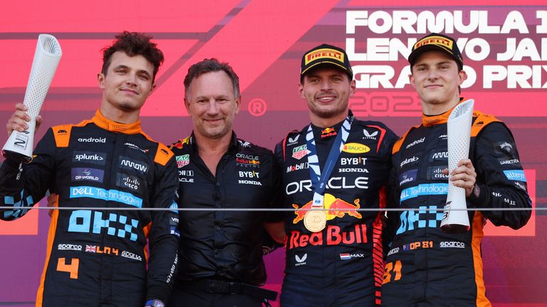 Lando Norris, Christian Horner, Max Verstappen and, Oscar Piastri celebrate on the podium at the 2023 Japanese GP
