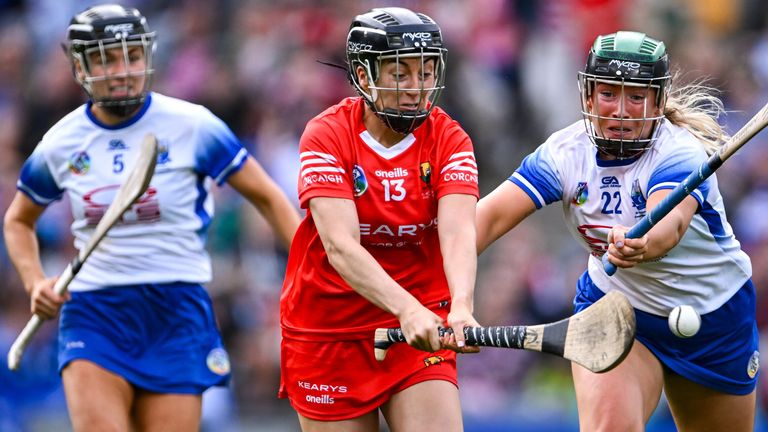 Amy O'Connor of Cork shoots to score her side's fourth goal, and her hat-trick, under pressure from Laoise Forrest of Waterford, right, during the Glen Dimplex All-Ireland Camogie Championship Premier Senior Final match between Waterford and Cork at Croke Park in Dublin