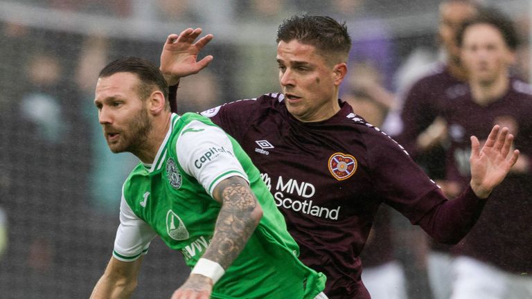 EDINBURGH, SCOTLAND - OCTOBER 07: Hibernian's Martin Boyle (L) and Hearts' Cammy Devlin in action during a cinch Premiership match between Heart of Midlothian and Hibernian at Tynecastle Park, on October 07, 2023, in Edinburgh, Scotland. (Photo by Mark Scates / SNS Group)