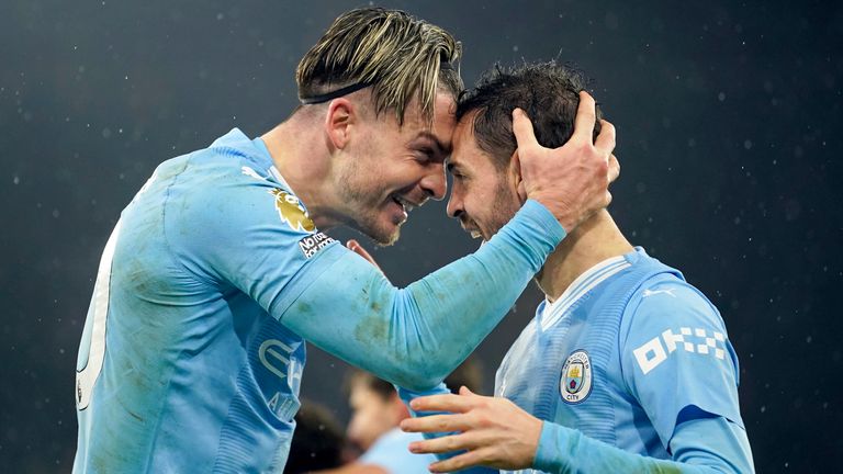 Manchester City's Jack Grealish celebrates with Bernardo Silva after scoring his side's third goal