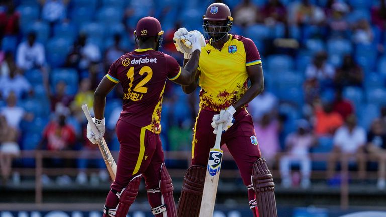 Jason Holder celebrates with Andre Russell after hitting a six during West Indies&#39; innings