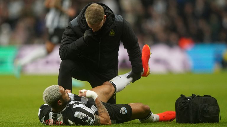 Newcastle United's Joelinton receives treatment for an injury 