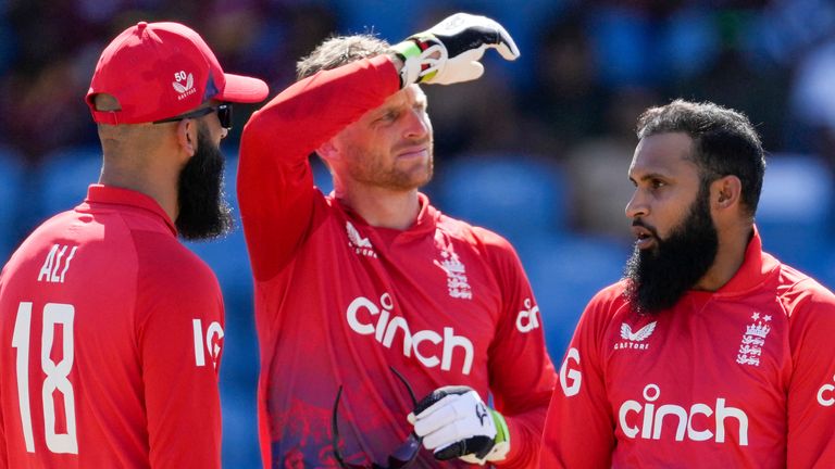 England&#39;s bowler Adil Rashid, right, celebrates with Moeen Ali and captain Jos Buttler the dismissal of West Indies&#39; Shai Hope during the third T20 cricket match at National Cricket Stadium in Saint George&#39;s, Grenada, Saturday, Dec. 16, 2023. (AP Photo/Ricardo Mazalan)