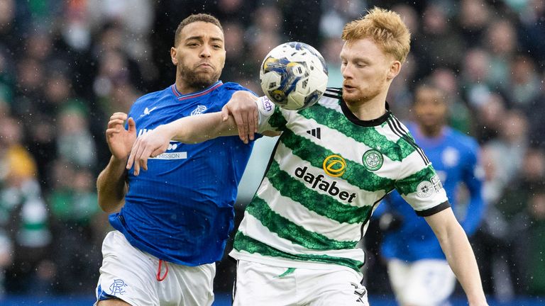 Celtic's Liam Scales and Rangers' Cyriel Dessers battle for the ball