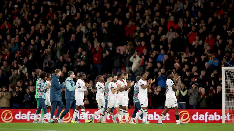 Luton players applaud fans as they make their way around the stadium after the game was abandoned following the collapse of team-mate Tom Lockyer 