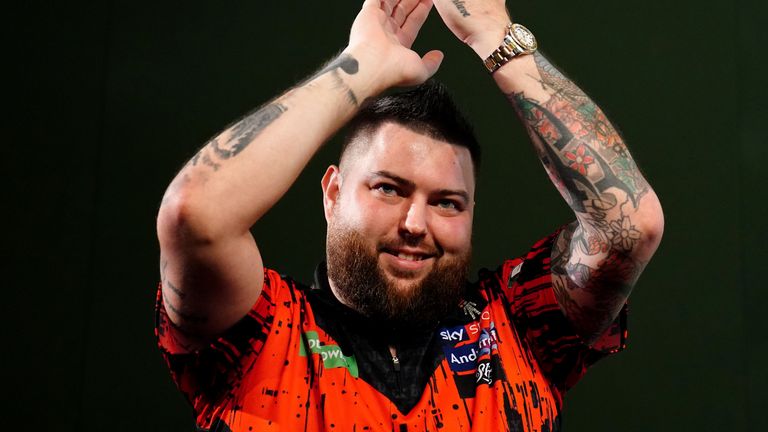 Michael Smith celebrates his second-round win over Kevin Doets at the World Darts Championship