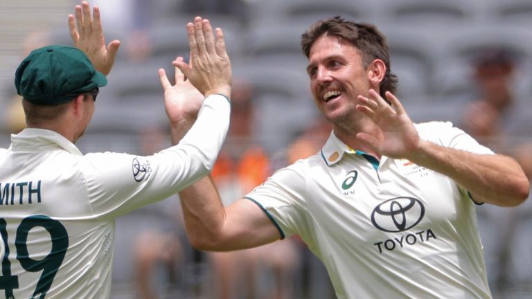 Mitchell Marsh, center, of Australia is congratulated by teammates after dismissing Babar Azam, not pictured, of Pakistan during play on the third day of the first cricket test between Australia and Pakistan in Perth, Australia, Saturday, Dec. 16, 2023. (Richard Wainwright/AAP Image via AP)