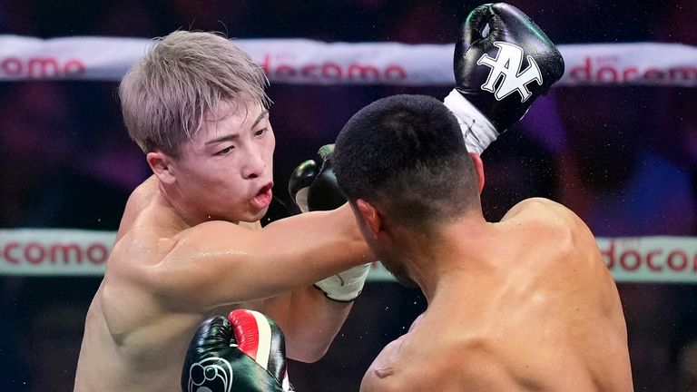Naoya Inoue of Japan punches Marlon Tapales of the Philippines in the third round of their boxing match for the unified WBA, WBC, WBO and IBF super bantamweight world titles in Tokyo, Tuesday, Dec. 26, 2023. (AP Photo/Hiro Komae)