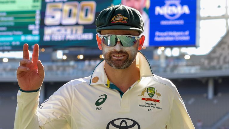 Australia's Nathan Lyon gestures as he leaves the field at the end of play on the fourth day of the first cricket test between Australia and Pakistan in Perth after taking his 500th test wicket (Richard Wainwright/AAP Image via AP)