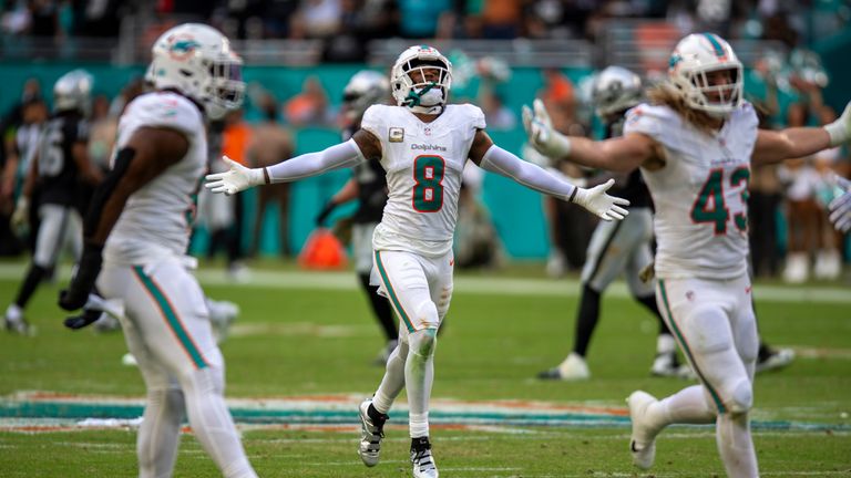 Miami Dolphins safety Jevon Holland (8) and teammates celebrate a defensive stop against the Las Vegas Raiders.