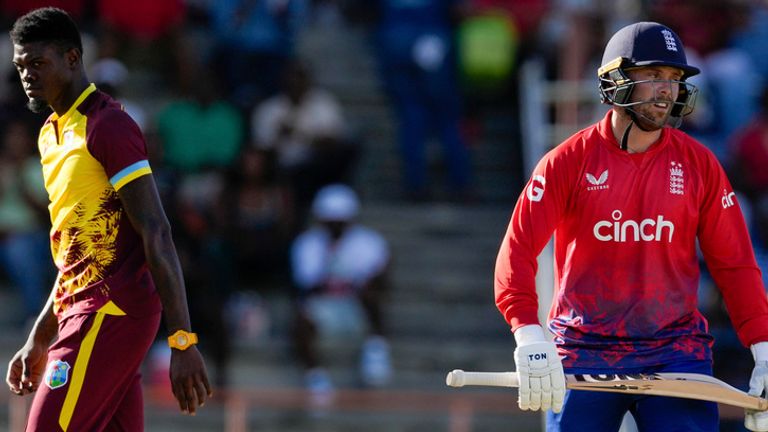 England's Phil Salt..walks off the field after his dismissal as West Indies' bowler Alzarri Joseph looks on during the second T20 cricket match at National Cricket Stadium in Saint George's, Grenada, Thursday, Dec. 14, 2023. (AP Photo/Ricardo Mazalan)