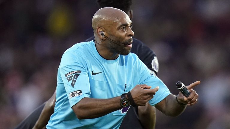 Referee Sam Allison communicates a decision during Sheffield United's Premier League clash with Luton Town