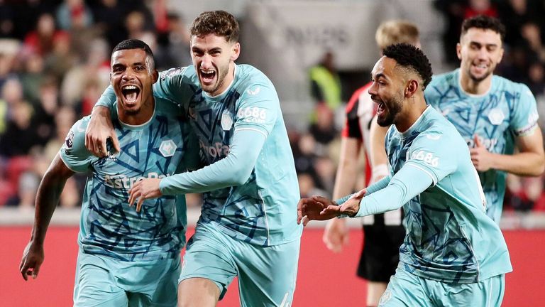 Mario Lemina celebrates with team-mates Santiago Bueno and Matheus Cunha after opening the scoring for Wolves at Brentford