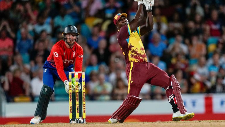 West Indies' Roman Powell hits a six against England during the first T20 cricket match at Kensington Oval in Bridgetown, Barbados, Tuesday, Dec. 12, 2023. (AP Photo/Ricardo Mazalan)