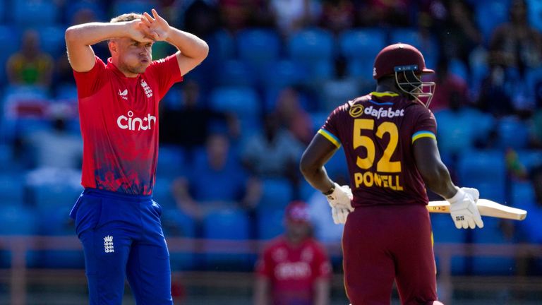 England's Sam Curran..reacts as West Indies' captain Rovman Powell scores runs from his bowling during the third T20 cricket match at National Cricket Stadium in Saint George's, Grenada, Saturday, Dec. 16, 2023. (AP Photo/Ricardo Mazalan)