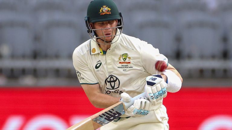 Steve Smith of Australia reacts as he is struck on the arm while batting during play on the third day of the first cricket test between Australia and Pakistan in Perth, Australia, Saturday, Dec. 16, 2023. (Richard Wainwright/AAP Image via AP)