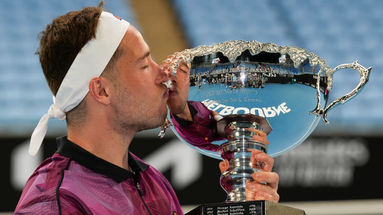 Alfie Hewett  kisses his trophy after defeating Tokito Oda of Japan in the men's wheelchair final at the Australian Open