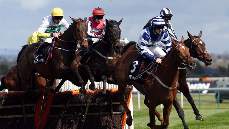 Three Stripe Life ridden by jockey Davy Russell (left) clear a fence on their way to winning the Betway Mersey Novices&#39; Hurdle during Grand National Day of the Randox Health Grand National Festival 2022 at Aintree with Might I leading