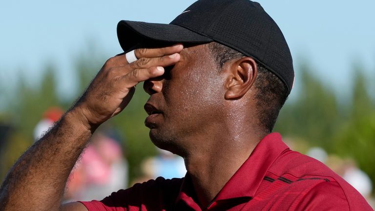 An exhausted Tiger Woods, from the United States, wipes the sweat off his brow after his final round of the Hero World Challenge PGA Tour at the Albany Golf Club, in New Providence, Bahamas, Sunday, Dec. 3, 2023. (AP Photo/Fernando Llano)